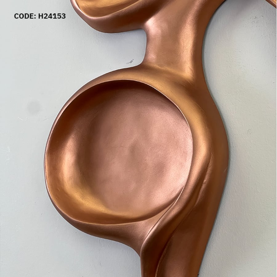 A modern wall masterpiece with a sculpted design in luxurious copper.