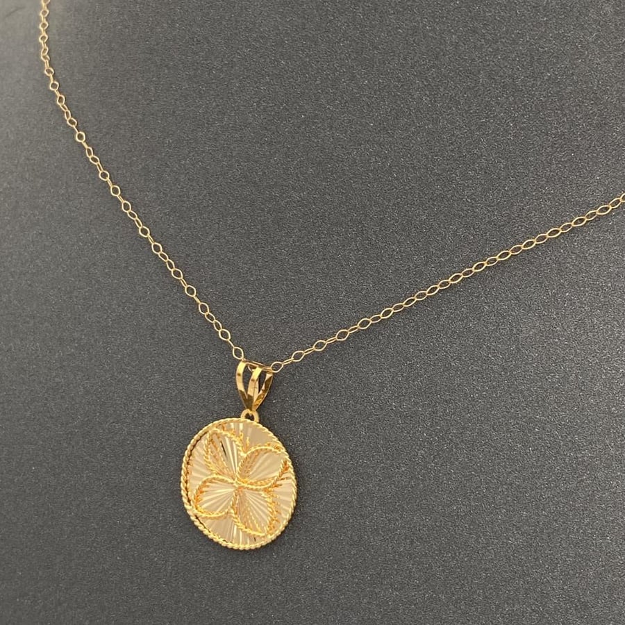 21 karat gold healing angle necklace, weight 1.74 grams