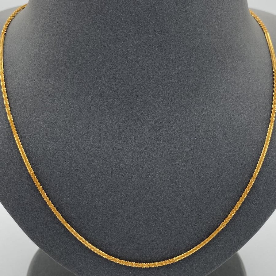 21-karat gold chain, weighing 8.36 grams