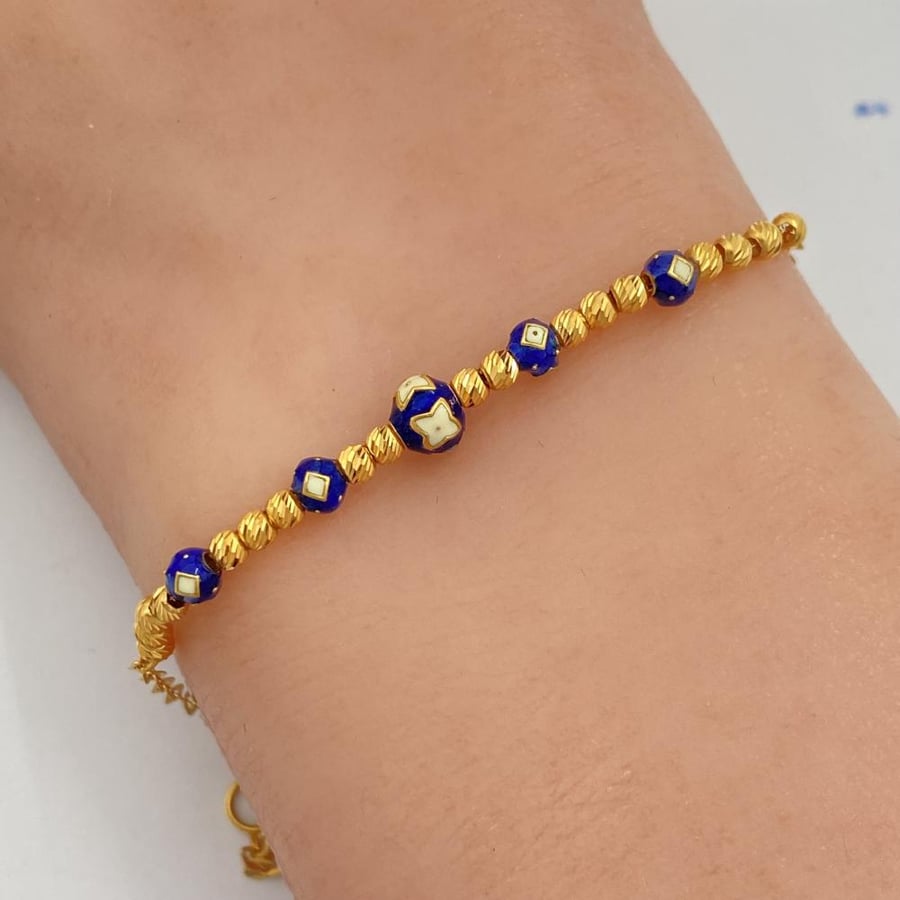 21 karat gold bracelet with blue beads, weight 2.57 grams