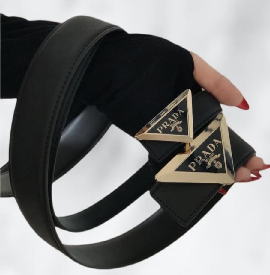 Luxury women's Prada belt - black leather with a golden triangular buckle