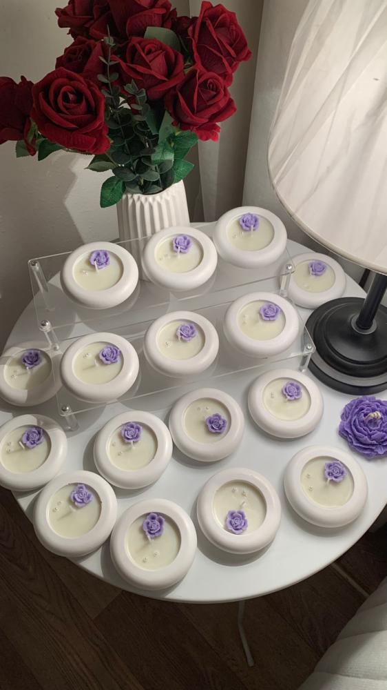 A candle with a ring, a circle, writing inside the candle