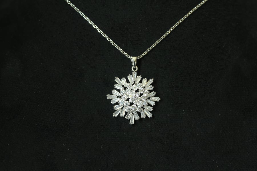 Luxurious necklace with a chain and pendant encrusted with zircon and plated with white gold