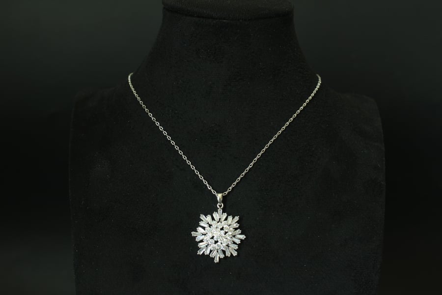 Luxurious necklace with a chain and pendant encrusted with zircon and plated with white gold