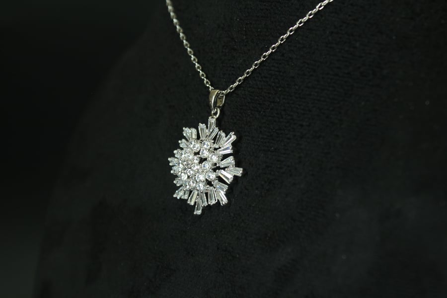 Luxurious necklace with a chain and pendant encrusted with zircon and plated with white gold