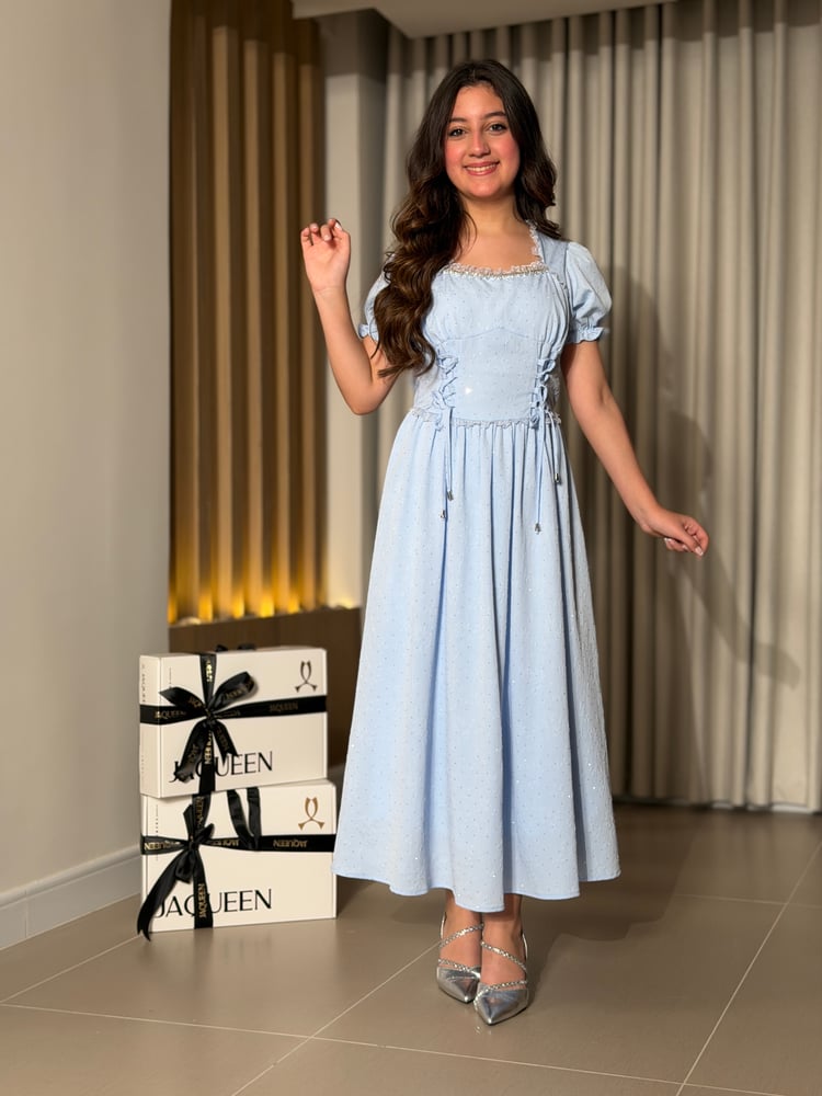 A soft blue dress with an elegant feminine design