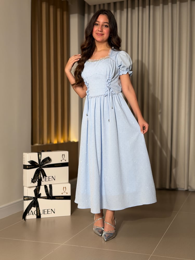 A soft blue dress with an elegant feminine design