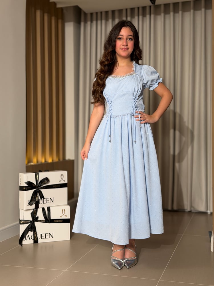A soft blue dress with an elegant feminine design
