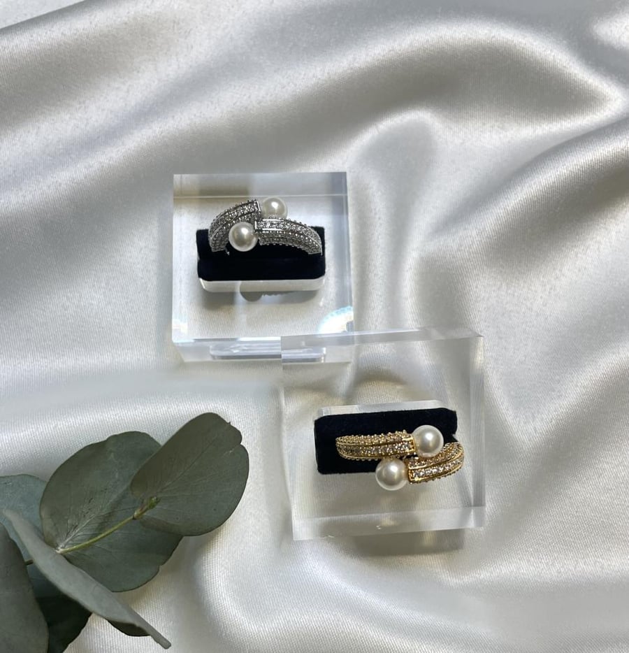 A ring set with zircon and decorated with pearls