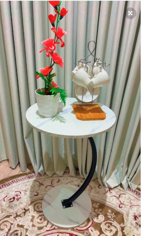 An elegant side table with a black marble surface