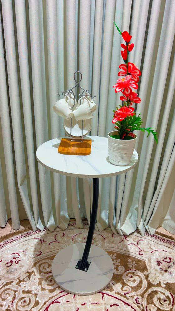 An elegant side table with a black marble surface