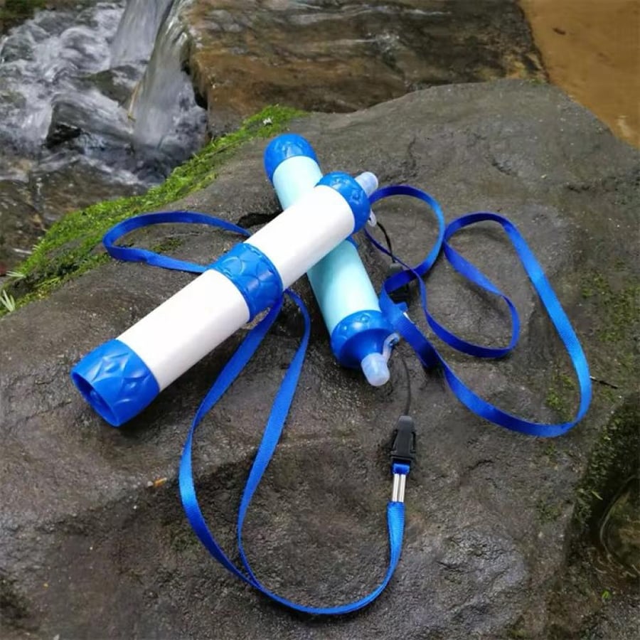 Two water filters on a rock near stream فلترا مياه على صخرة قرب جدول