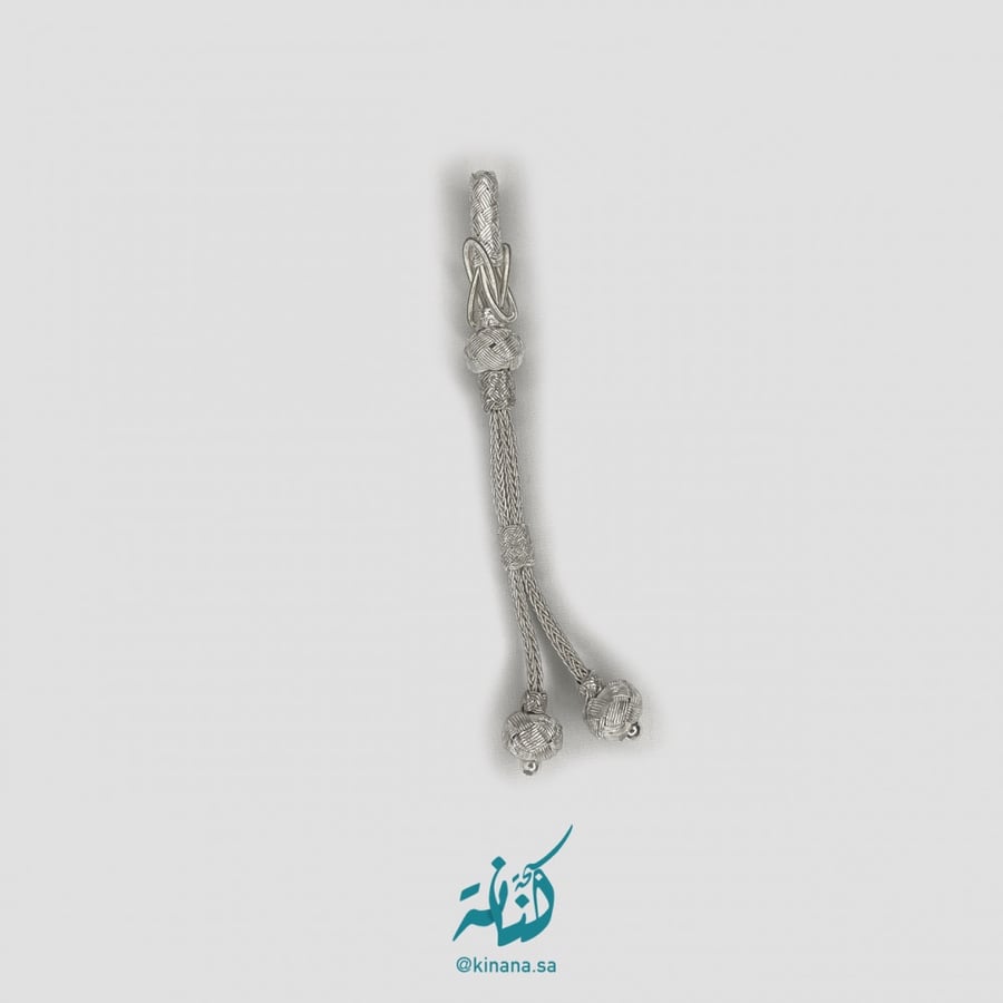 A small decorative item in silver color