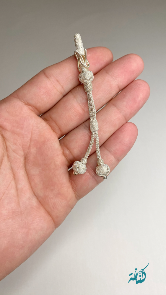 A small decorative item in silver color