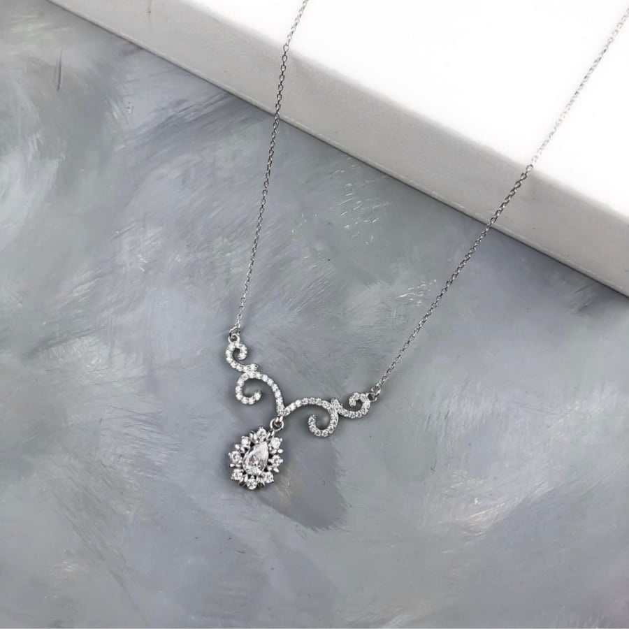 A set (necklace + earrings) silver encrusted with zircon