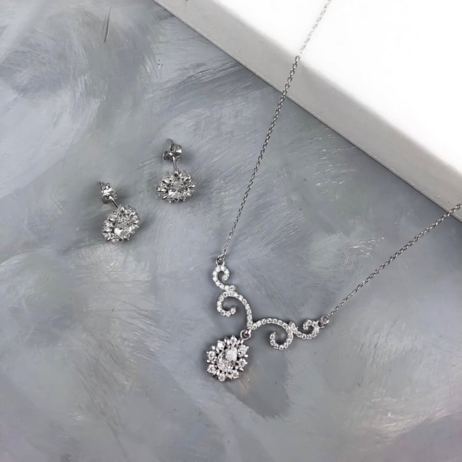 A set (necklace + earrings) silver encrusted with zircon