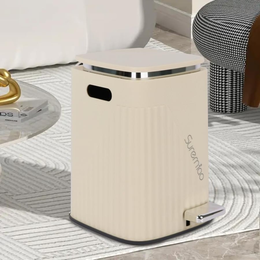 white plastic trash bin with a pedal