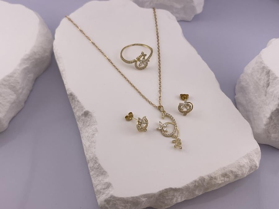 An elegant 18-karat gold set with a luxurious design and soft feminine touches