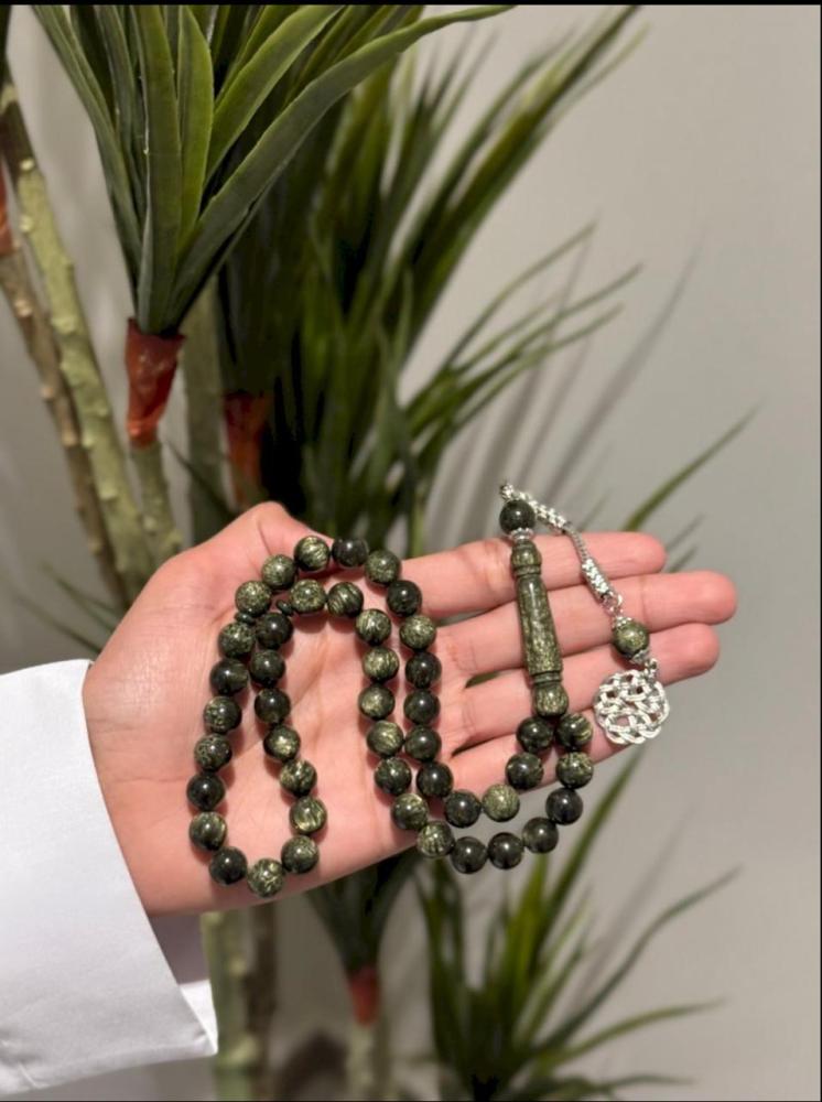 An olive-colored tasbih with a Turkish turban bead