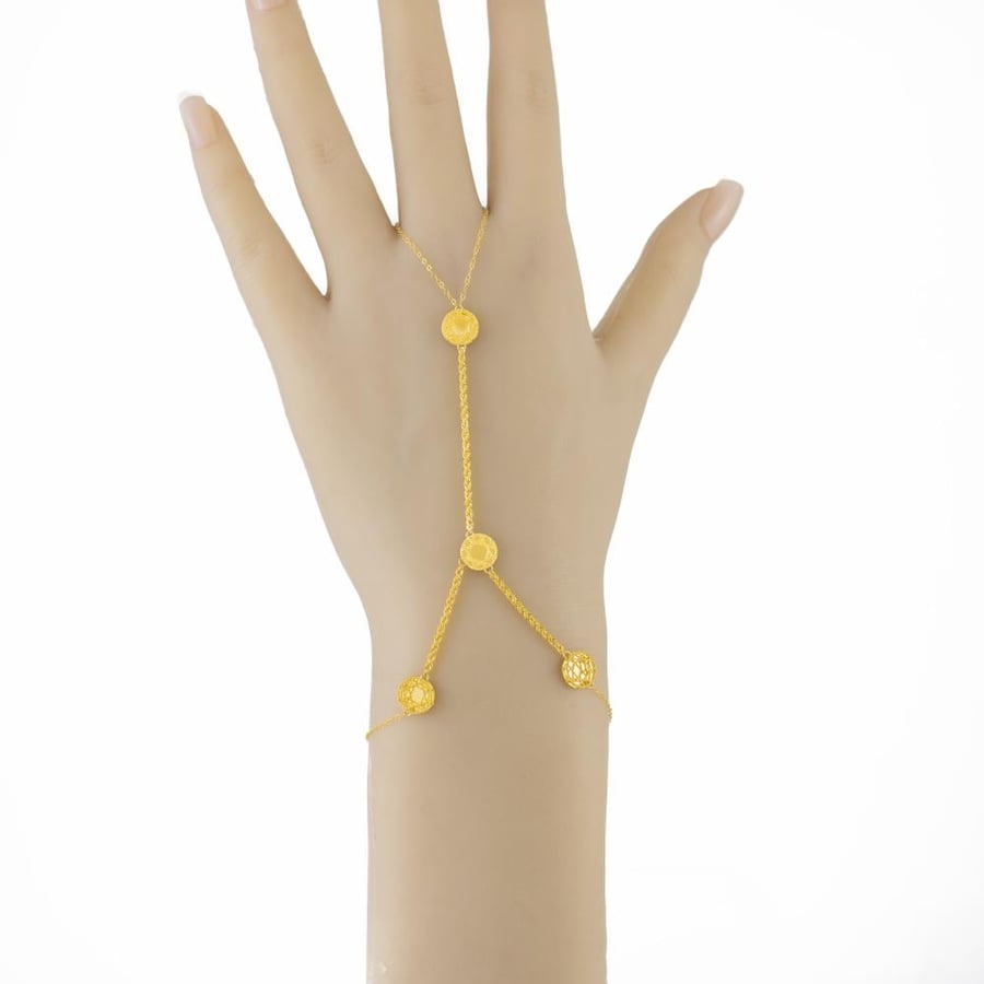 Pure 21-karat gold hand with a geometric circle design