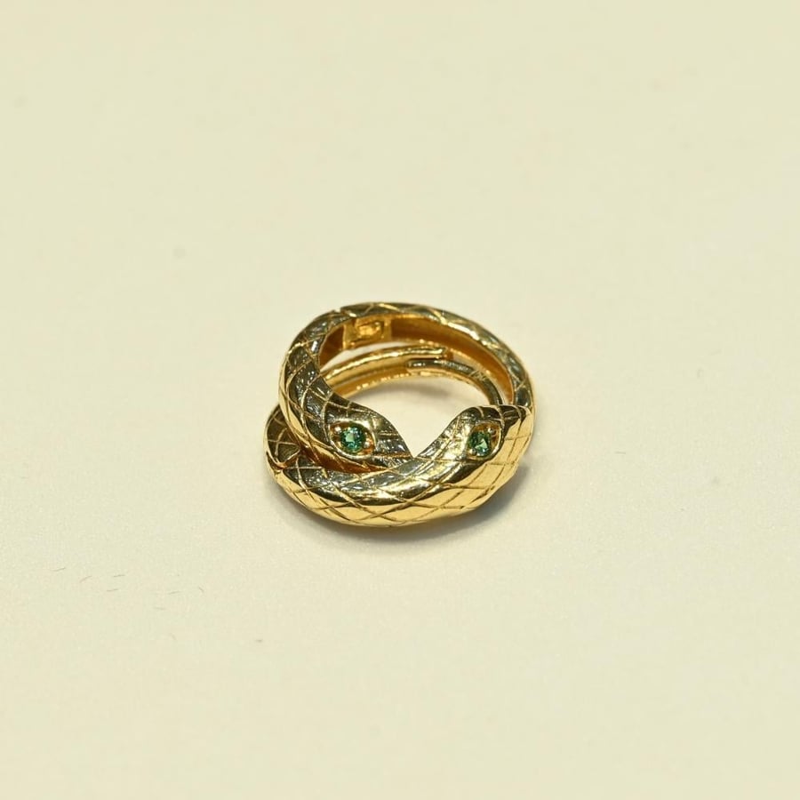 Gold snake ring with green eyes