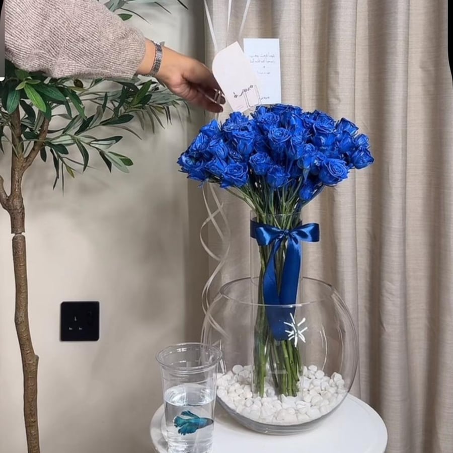 Two vases with blue roses