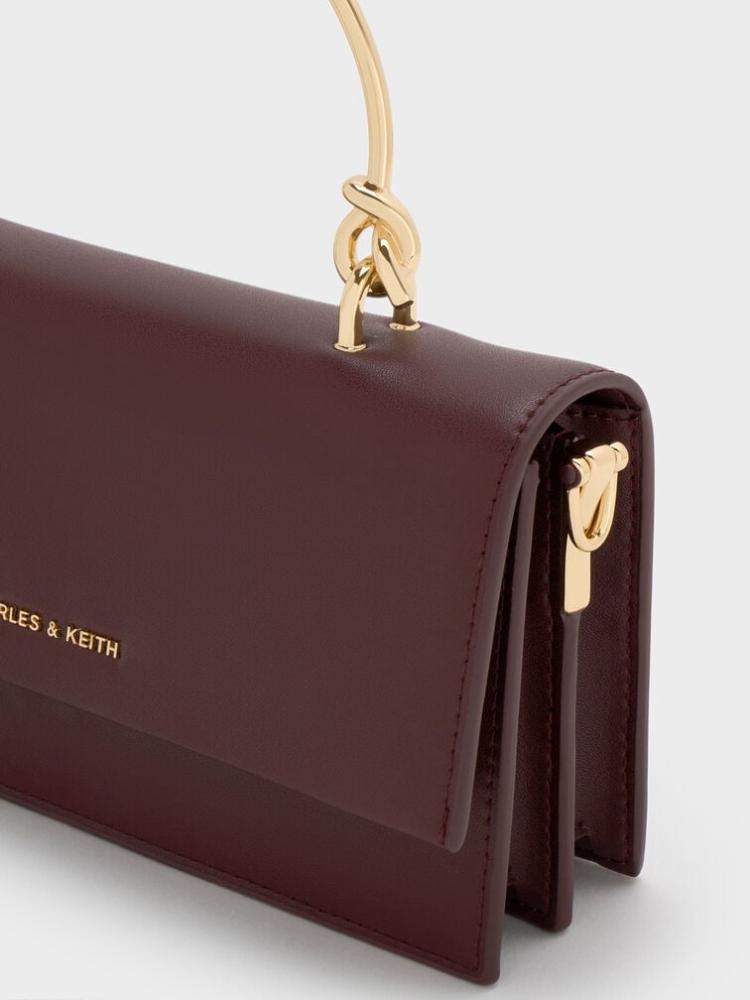 A maroon bag Charles and Keith