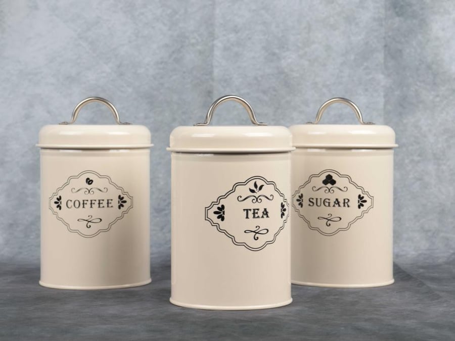 A set of sugar, tea, and coffee containers in beige color