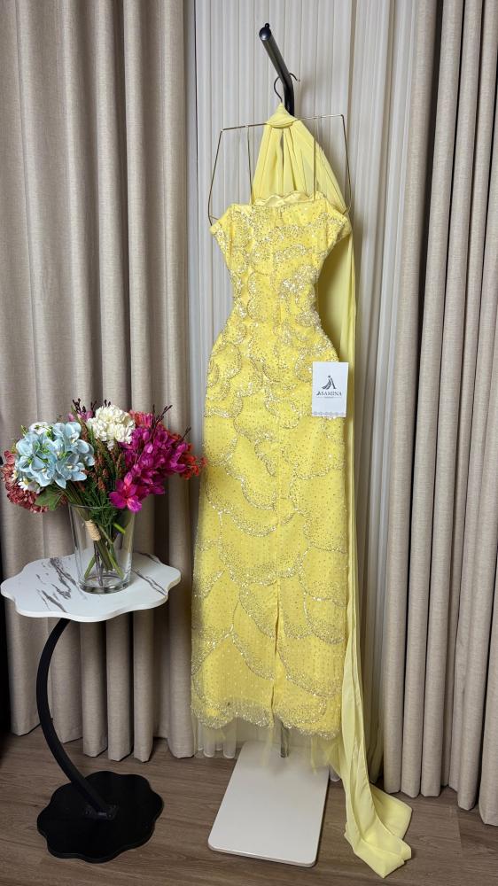 A yellow dress with a lining, a torn hem, and embroidered.