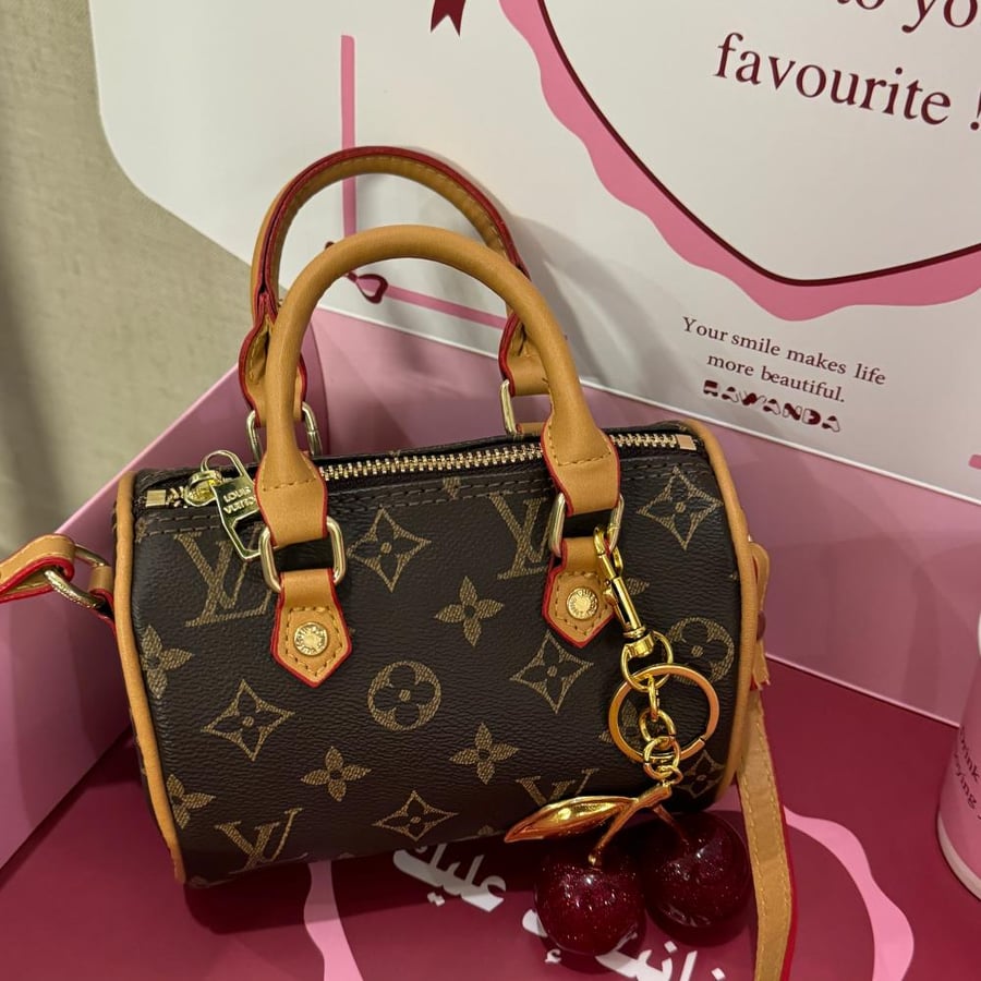 Louis Vuitton Nano Speedy bag with accessories and cherry medal
