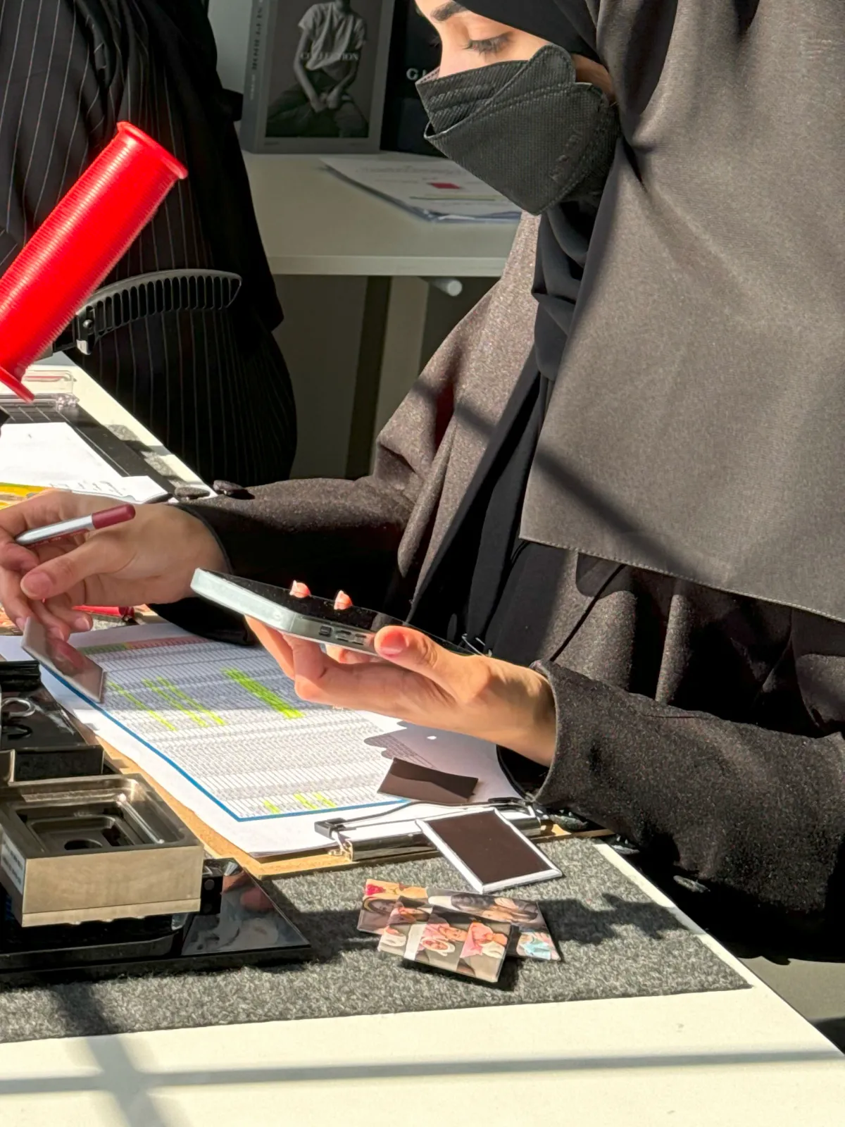 موظفة في ميار ميموريز تراجع طلب طباعة صور وتجهّز الصور المطبوعة