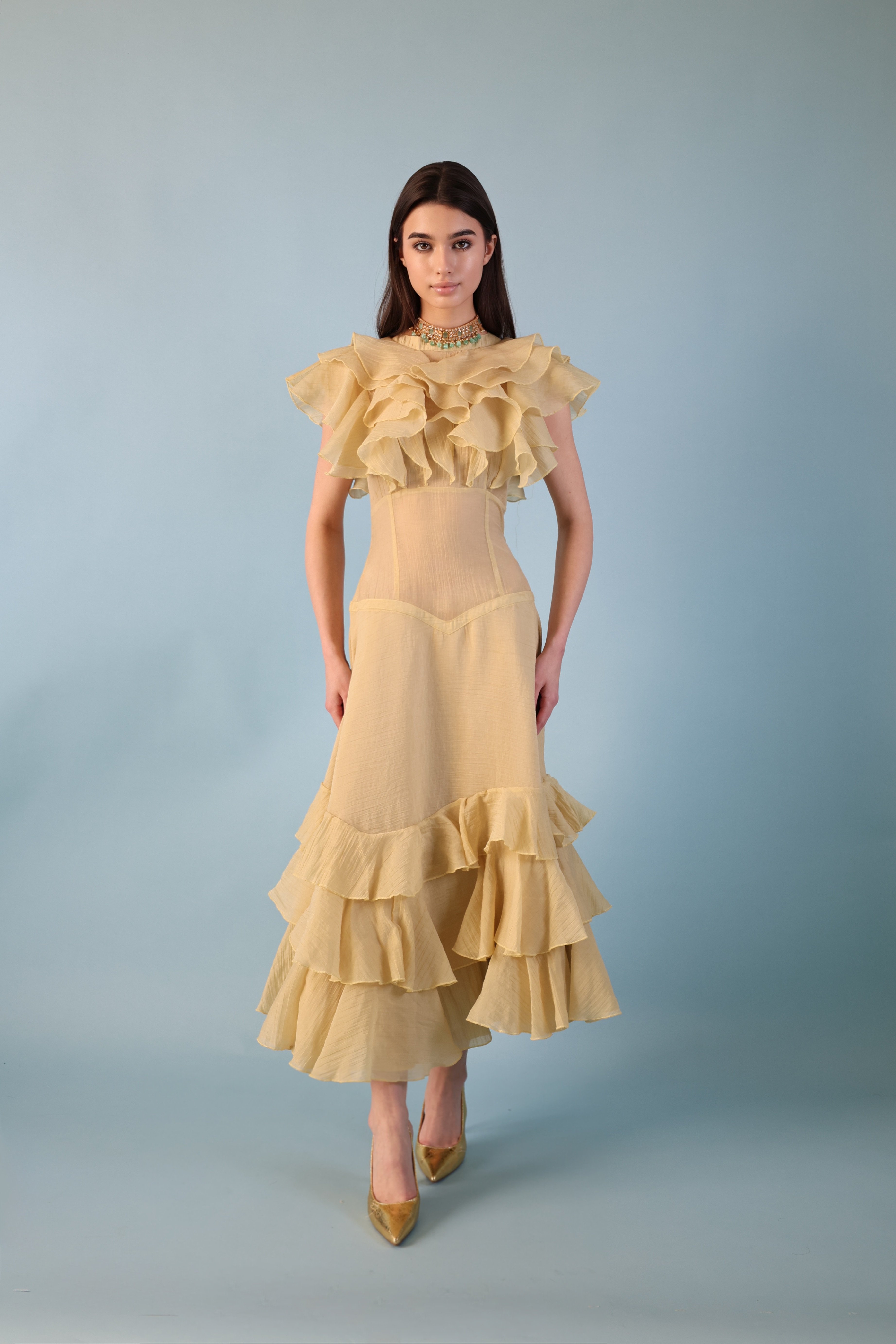 A beige-yellowish dress with A distinctive Design made of georgette fabric