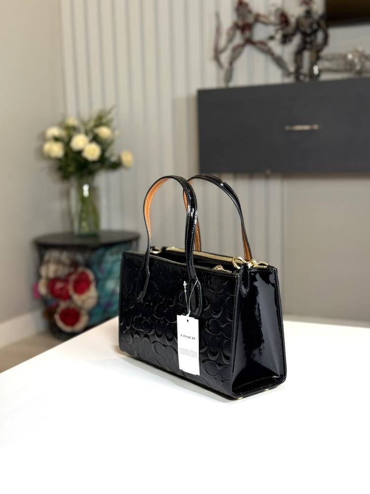 شنطة كوتش توت صغيره نينا سجنشر بلون اسود اامبوزد  Nina Small Tote Bag In Signature Leather Black