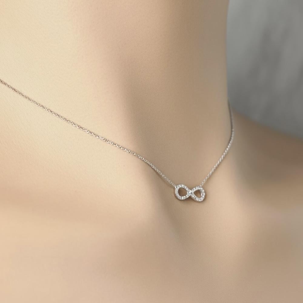 A delicate diamond necklace with a modern infinity symbol design
