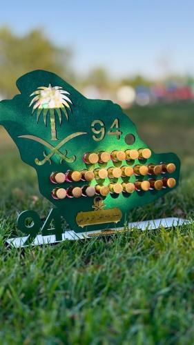 توزيعات اليوم الوطني تولات داخل استاند بشكل خريطة السعوديه