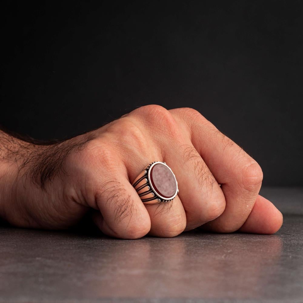 Men's silver ring decorated with a red agate stone pressed with wide horizontal engravings