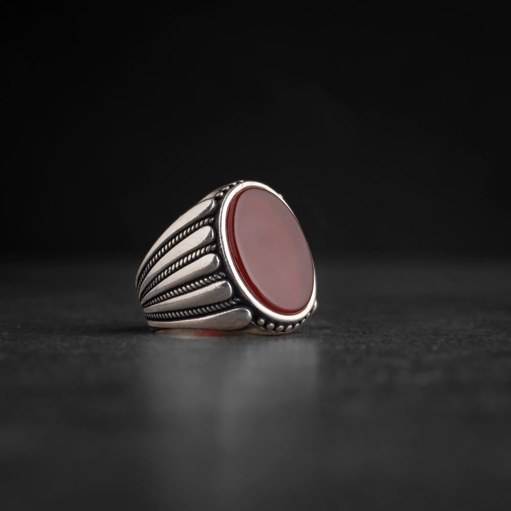 Men's silver ring decorated with a red agate stone pressed with wide horizontal engravings