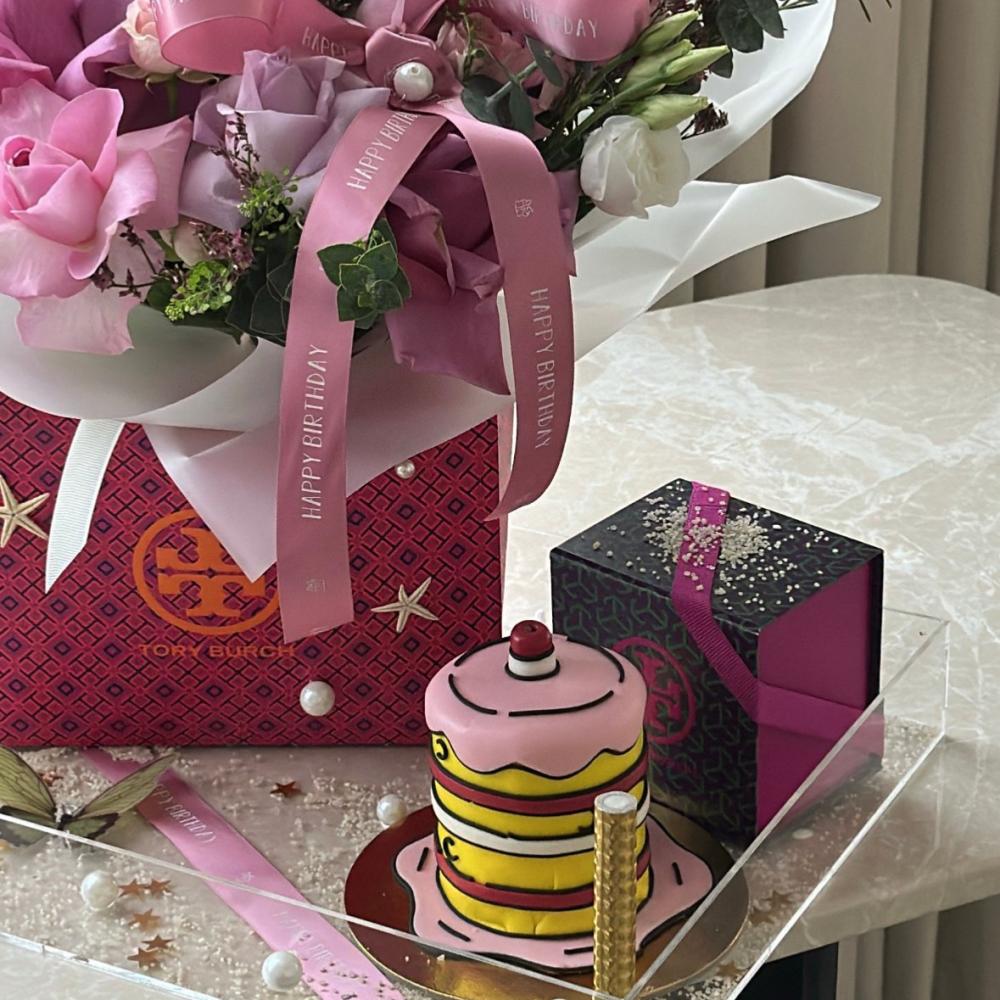 Bella's birthday stand and Tory Burch earrings