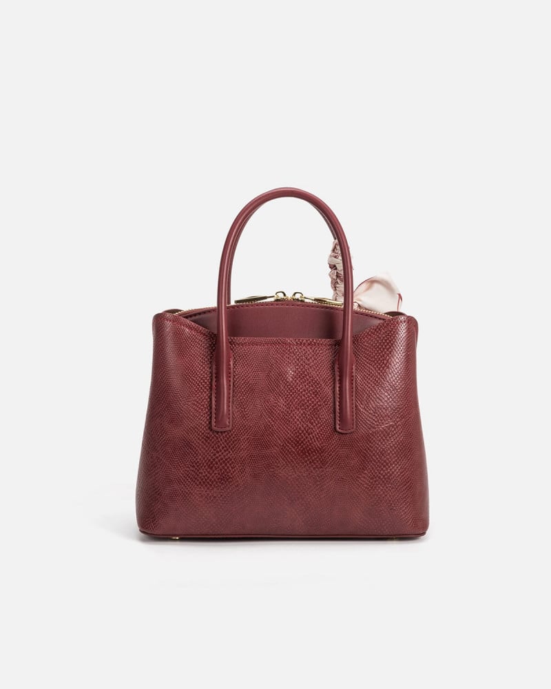 A women's bag of burgundy leather