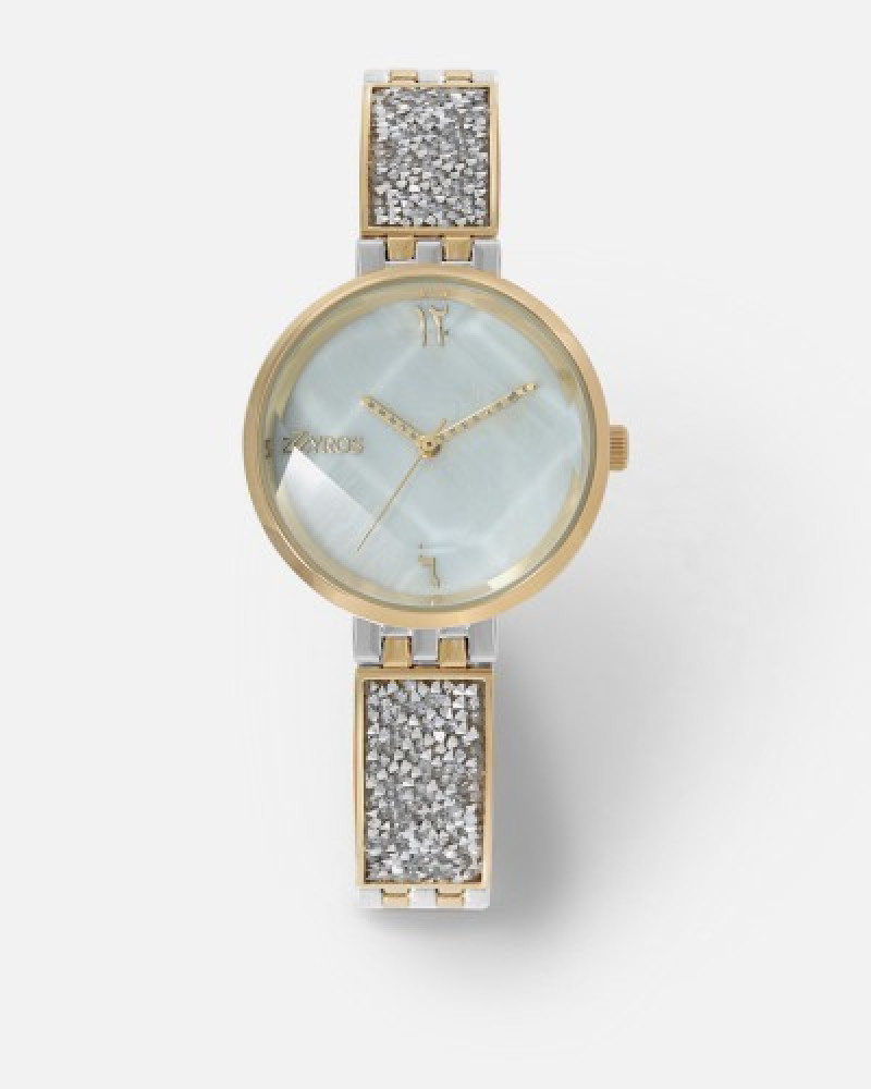 ‎ ساعة نسائية باللون الذهبي والفضي مع سوار مرصع بفصوص الزركون من زايروس  |  ZAO017L060629W
