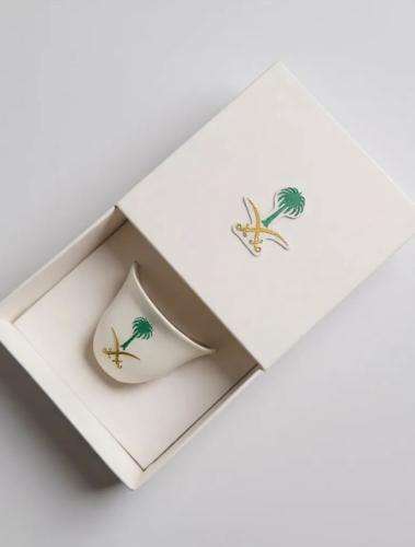 فنجان قهوة بشعار السيفين والنخلة