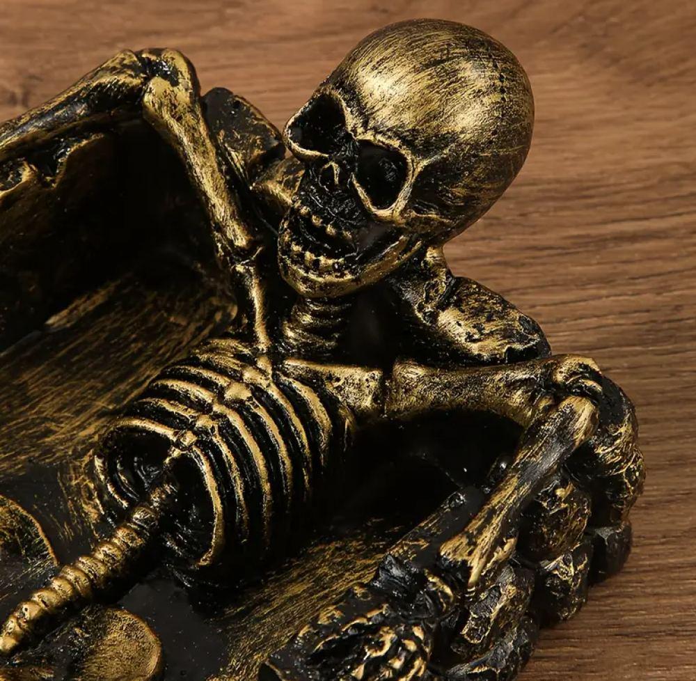 Decorative ashtray in the shape of a skull with a square base