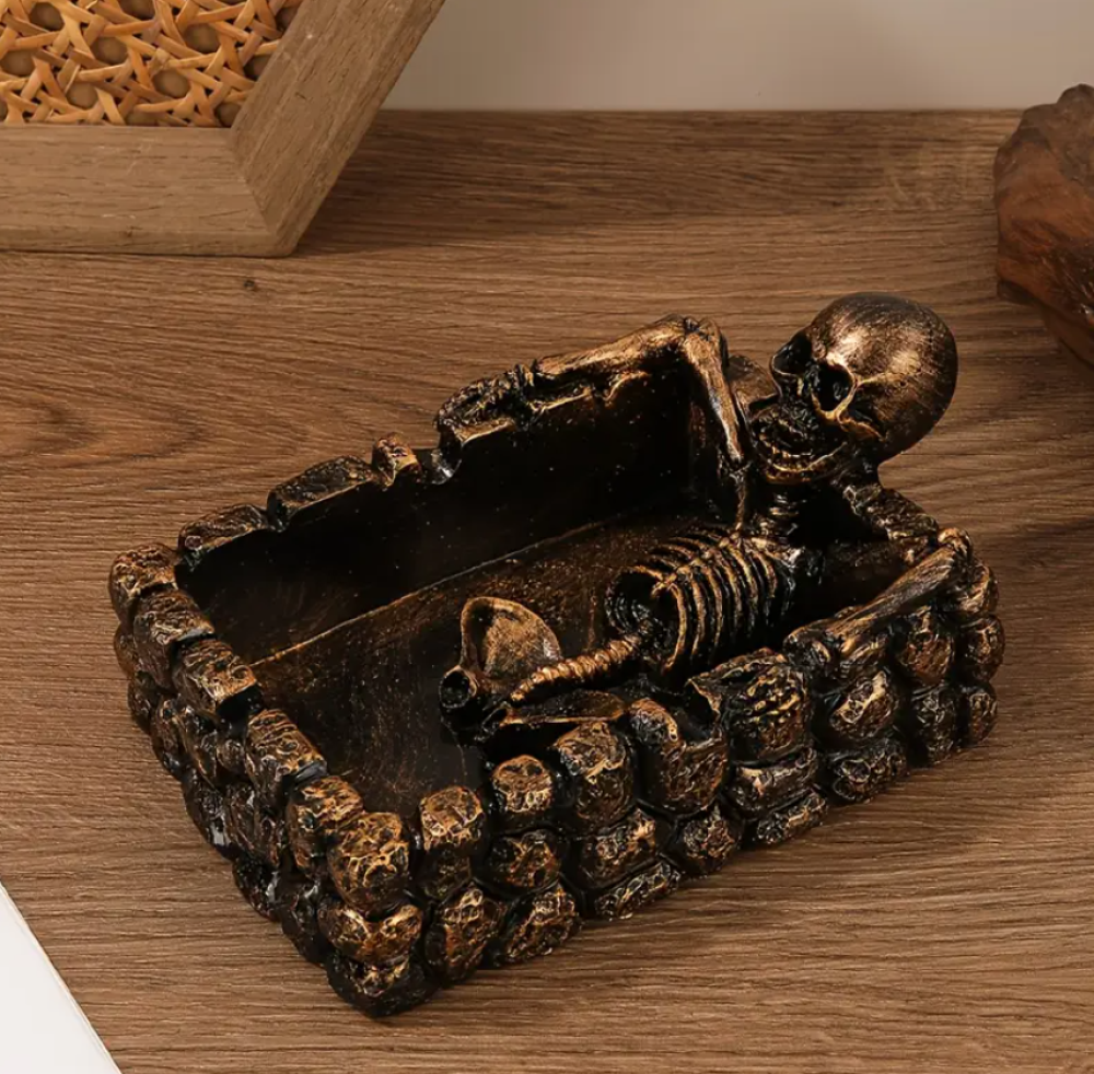 Decorative ashtray in the shape of a skull with a square base