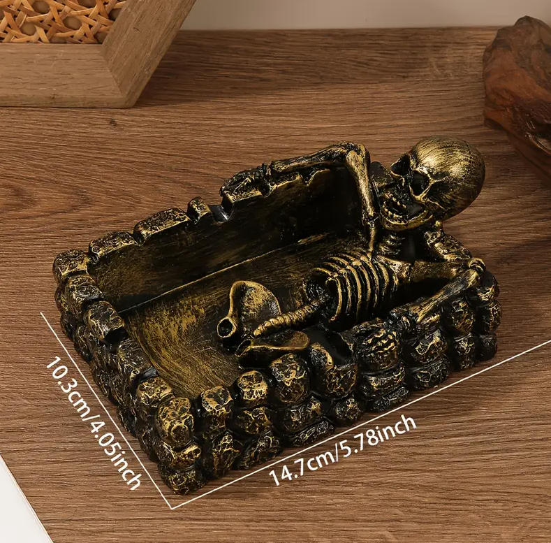 Decorative ashtray in the shape of a skull with a square base